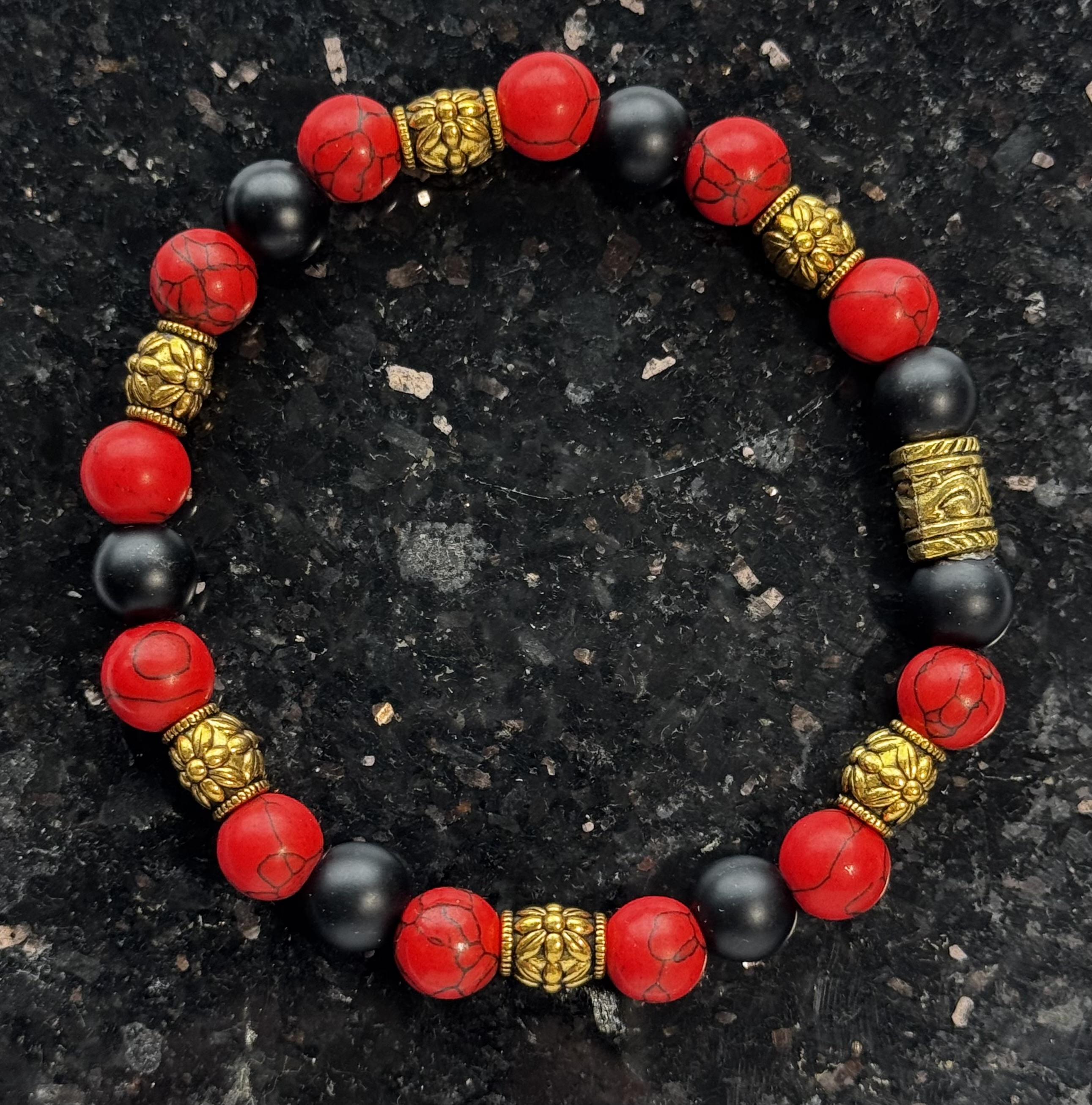 Red and black bracelet with gold accents